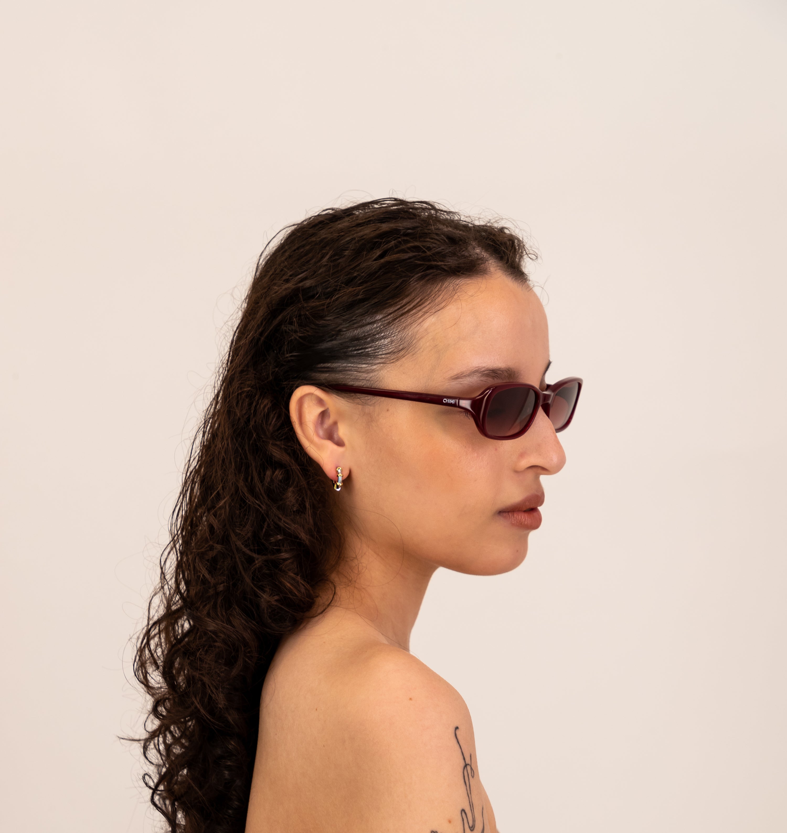 Person wearing sunglasses with a plain background